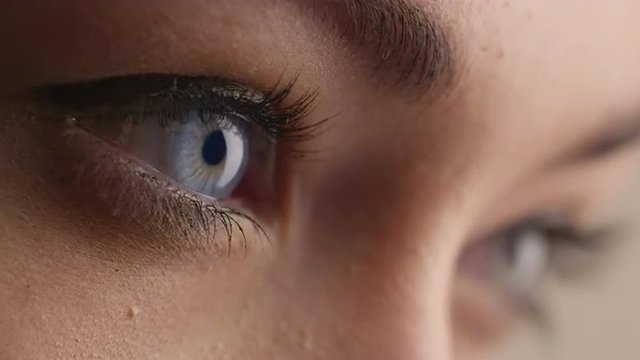 Close-up shot of woman blue eye with light day make-up. Shot on RED Cinema Camera.