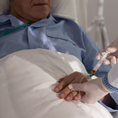 Obraz na płótnie Canvas Doctor performing a medical procedure