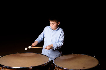 Fototapeta na wymiar Little drummer with drumsticks
