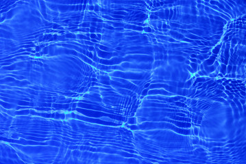 Sun reflections in pool water from above. 