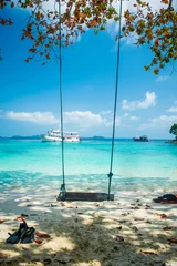 Door stickers Blue sky Swing in a perfect beautiful paradise beach with a ship, tourist