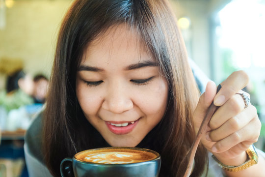 Beautiful cute asian girl in the art cafe  with coffee smiling