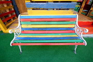 Multi colored bench made from different painted wooden boards
