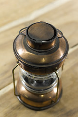 vintage style kerosene lamp, lantern on wooden background