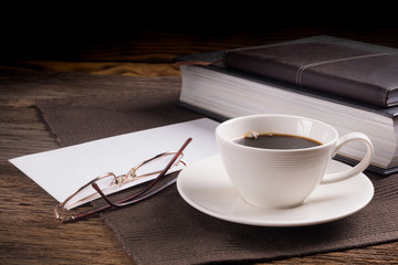 Cup of coffee with books