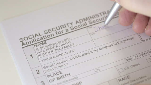 Man filling out Social Security Card Application Form