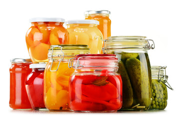 Fototapeta na wymiar Jars with pickled vegetables, fruity compotes and jams isolated