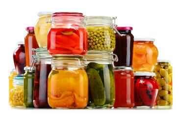 Jars with pickled vegetables, fruity compotes and jams isolated