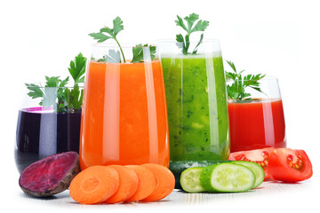 Glasses with fresh vegetable juices isolated on white