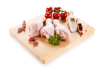 Raw chicken legs on cutting board 