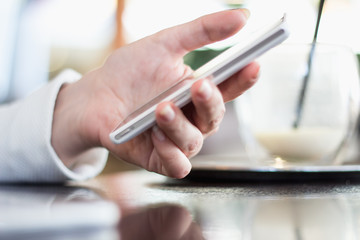 woman holds a smartphone telephone, works on the digital tablet, soft focus, close up