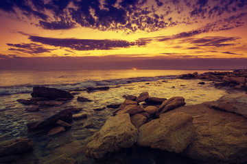 Fototapeta na wymiar Wild rocky beach at dawn