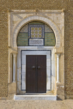 Tunisia. Kairouan - the Zaouia of Sidi Saheb. Richlly decorate door with ornamental tiles and Arabic inscription