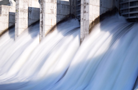 Water rushing out of opened gates of a hydro electric power dam in long exposure