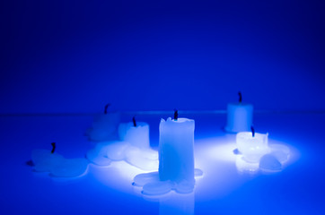 Extinguished candles in blue
