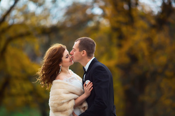 Happy Bride and groom, on background autumn park