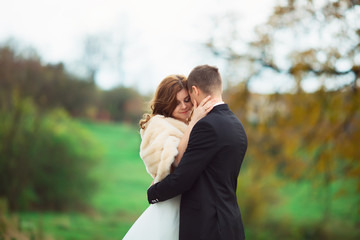 Fototapeta premium couple kissing in honeymoon outdoor autumn park
