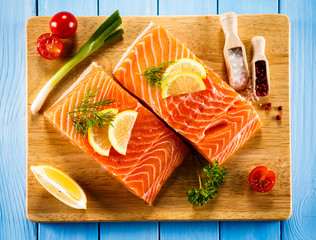 Fresh raw salmon fillets on cutting board 