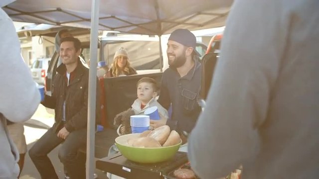 Slow Motion Shot Of Sports Fans Tailgating In Parking Lot