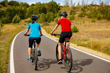 Healthy lifestyle - teenage girl and boy cycling 