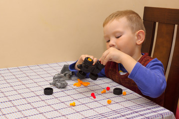 the boy assembles the machine