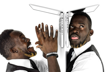 African businessman double portrait working at laptop