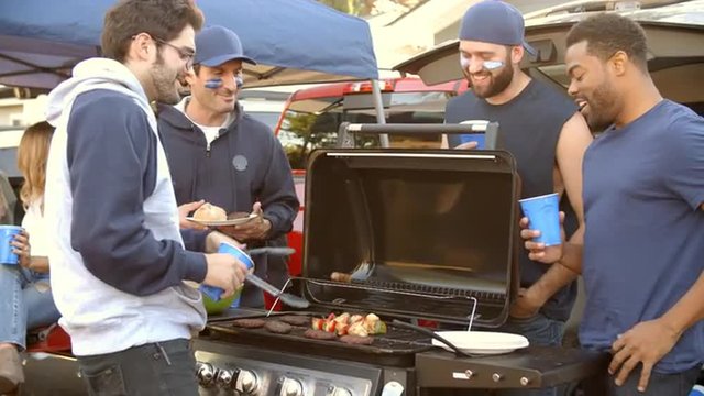 Slow Motion Shot Of Sports Fans Tailgating In Parking Lot