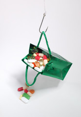 Fishing hook holding a bag with medicines