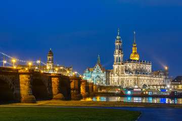 Fototapeta na wymiar Dresden Cathedral of the Holy Trinity aka Hofkirche Kathedrale Sanctissima Trinitatis and Augustus Bridge with reflections in the river Elbe at night in Dresden, Saxony, Germany