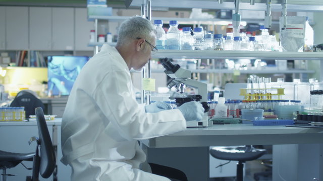  Male scientist is working on a microscope in a laboratory. Shot on RED Cinema Camera.