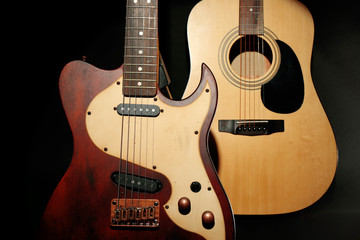 Electric and acoustic guitars on dark grey background