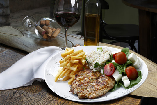 Meal with rice, meat, french fries and salad
