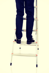 Close up male legs climbing ladder