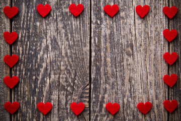 Brown wooden background with red hearts.