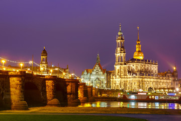 Fototapeta na wymiar Dresden Cathedral of the Holy Trinity aka Hofkirche Kathedrale Sanctissima Trinitatis and Augustus Bridge with reflections in the river Elbe at night in Dresden, Saxony, Germany