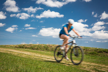 Fototapeta na wymiar Pretty, young female biker outdoors on her mountain bike 