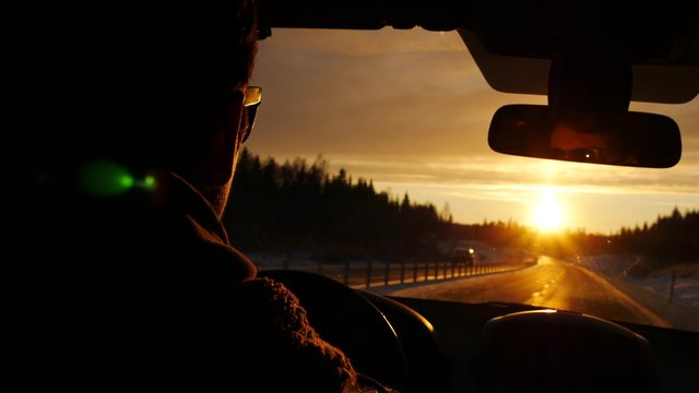 Driver in car through winter road on tourist travel roadtrip alone