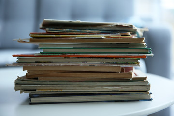 Pile of old books on white table