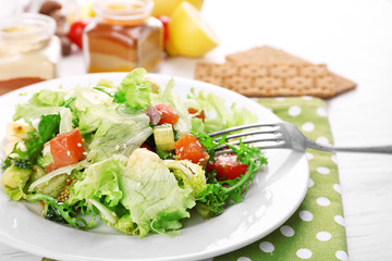 Tasty salmon salad on light wooden background