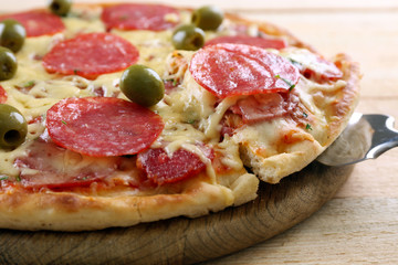 Delicious tasty pizza with cut slice, closeup