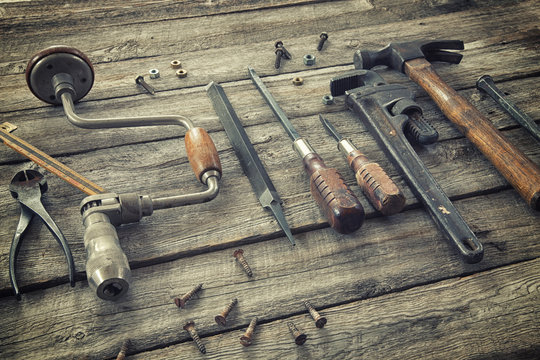 Old tools on rough wood surface
