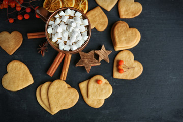 Fototapeta na wymiar Heart shaped biscuits with marshmallow and sweet spaces on a table