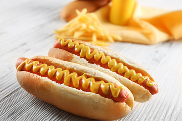 Hot dogs with cheese on wooden background