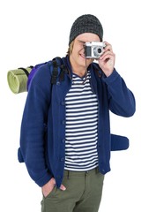 Backpacker hipster taking pictures with a retro camera