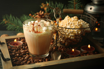 Cup of hot cacao with marshmallow and cookies on coffee beans