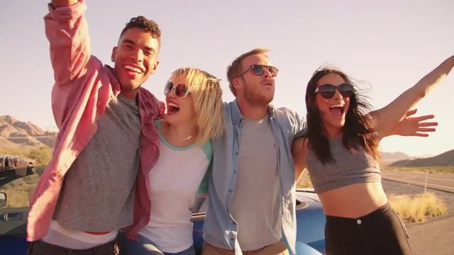 Friends On Road Trip Standing By Convertible Car Shot On R3D