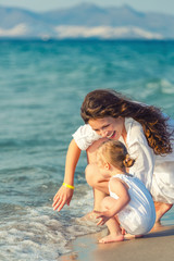 Fototapeta premium Mother and daughter playing on the beach