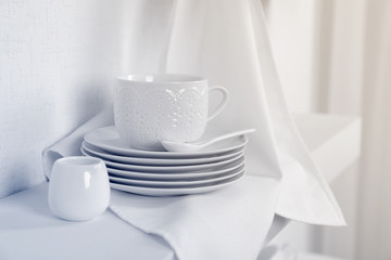 Tableware with napkin on a white background, close up