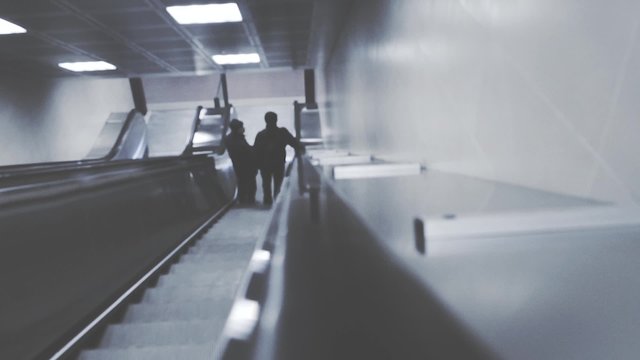 People on escalators in the underground in the modern city