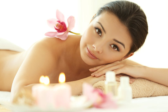 Spa concept. Young pretty woman relaxing on white background, close up